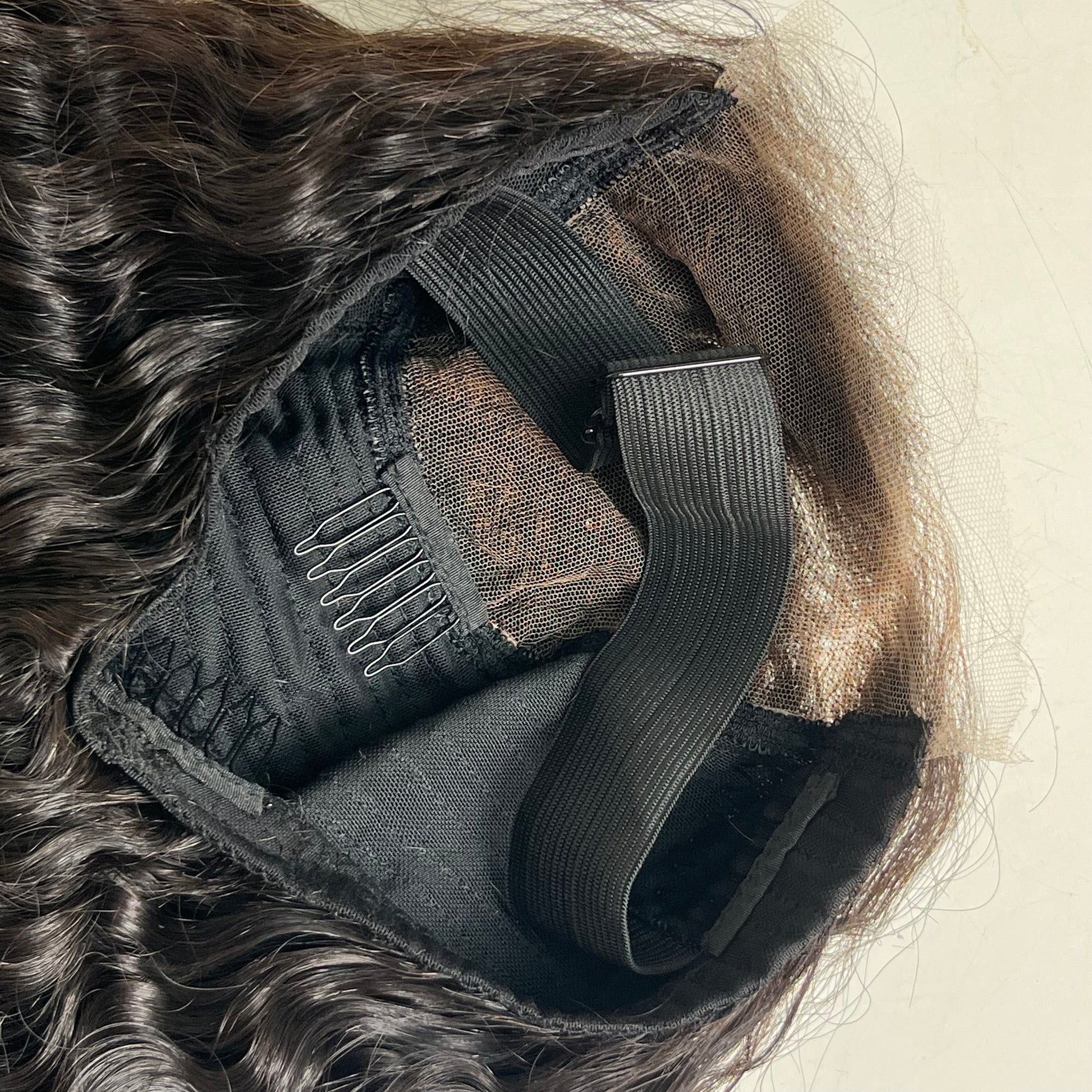 Close-up of a hair extension with a focus on the clip and mesh backing.